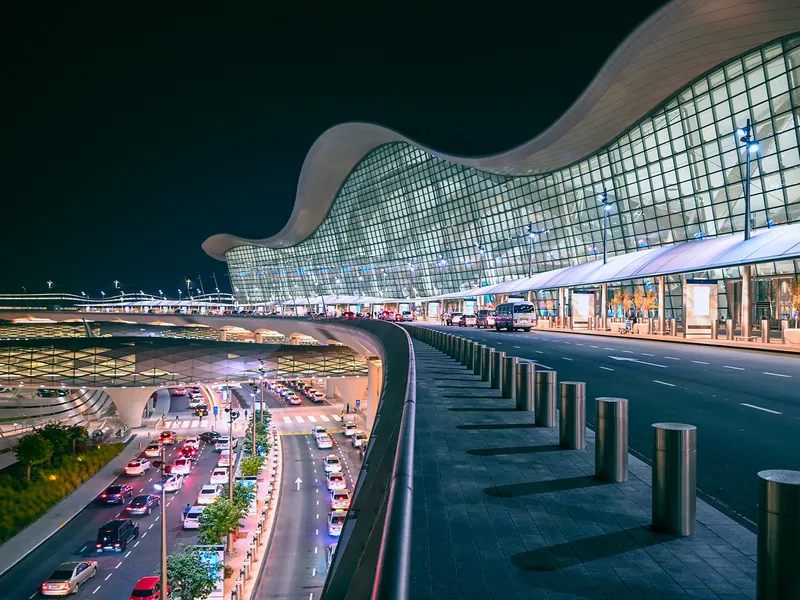 A photo of a large airport terminal at night.